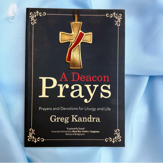 Book titled 'A Deacon Prays' by Greg Kandra with a cross on the cover against a light blue background.